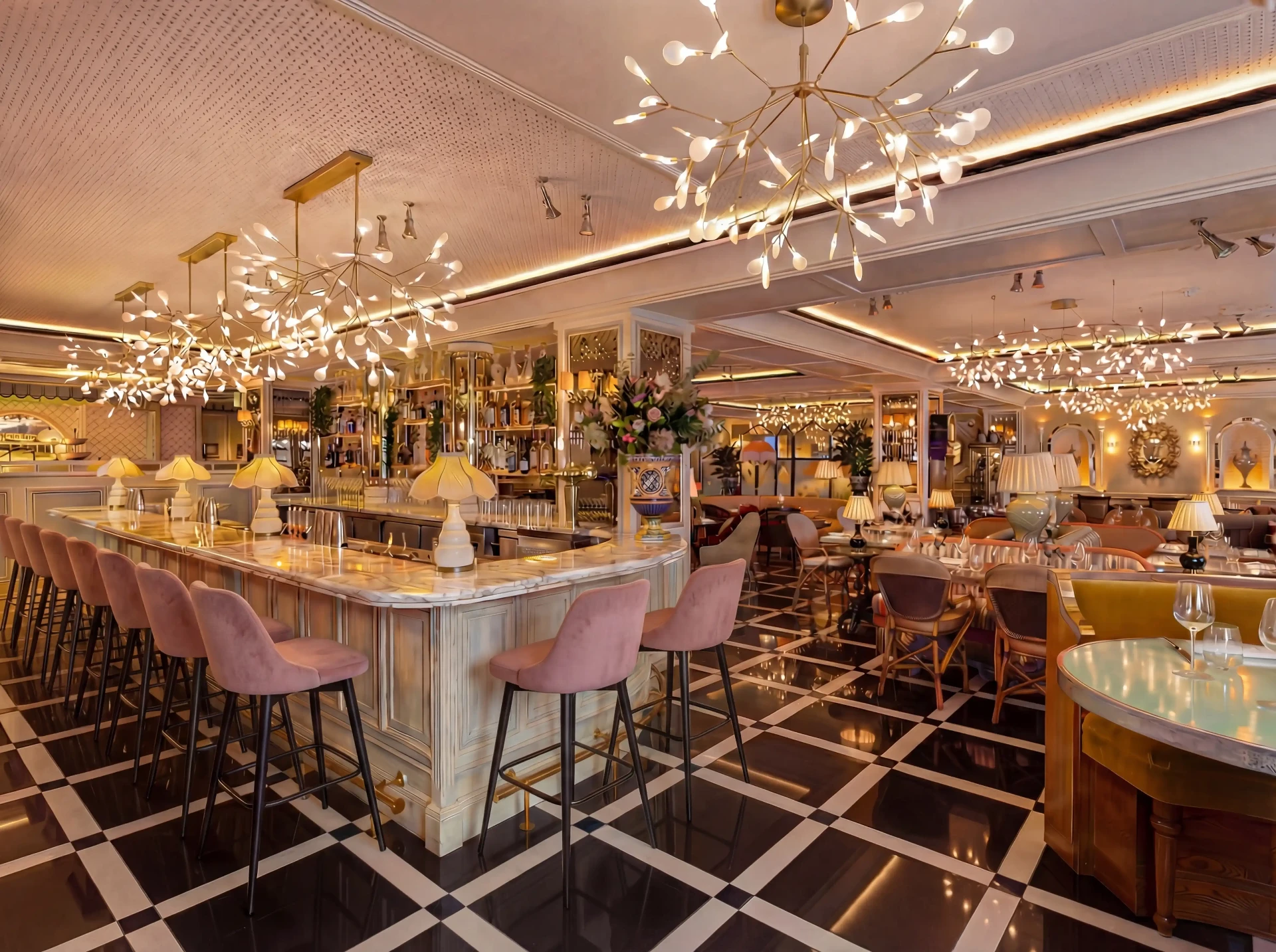 High-end modern restaurant bar with pink velvet stools and statement lighting — Italcasa Design