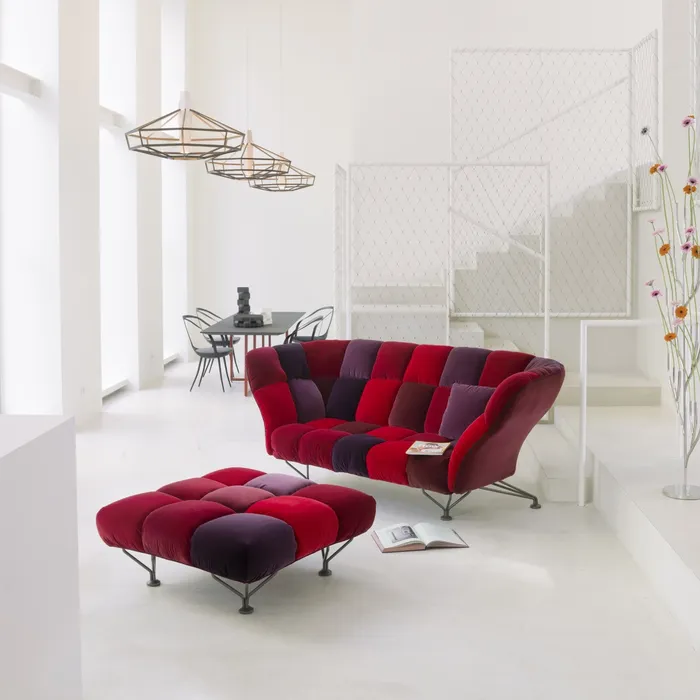 “33 Cuscini Sofa by Driade – contemporary sofa with 33 soft grey velvet cushions arranged in a grid pattern, set on a sleek black steel base, designed by Paolo Rizzatto, combining minimalist design with luxurious comfort.”