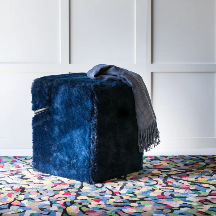 “Blocco Pouf by Driade – distinctive pouf featuring a wooden structure with black Mongolian fur upholstery, designed by Nanda Vigo, offering a bold and luxurious accent for modern living spaces.”