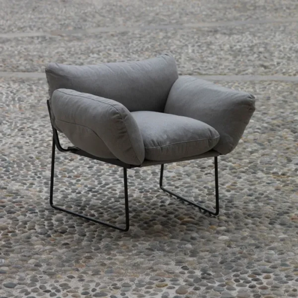 “Elisa Armchair by Driade – outdoor lounge chair with white waterproof upholstery and black-brown steel frame, designed by Enzo Mari, perfect for contemporary terraces and patios.”