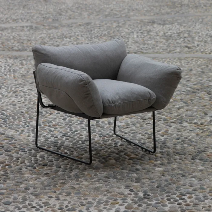 “Elisa Armchair by Driade – outdoor lounge chair with white waterproof upholstery and black-brown steel frame, designed by Enzo Mari, perfect for contemporary terraces and patios.”