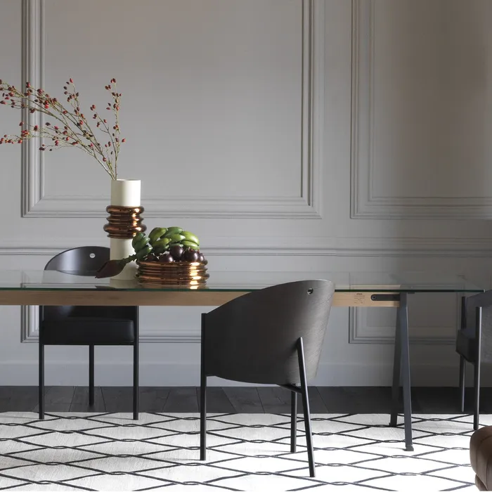 “Side view of FRATE 50° table by Driade – refined Italian design combining transparency and geometric metal structure”