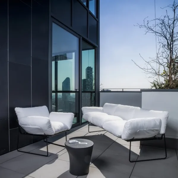 “Elisa Armchair by Driade – elegant lounge chair with soft grey upholstery and minimalist black-brown steel frame, designed by Enzo Mari, enhancing modern living spaces with refined design.”