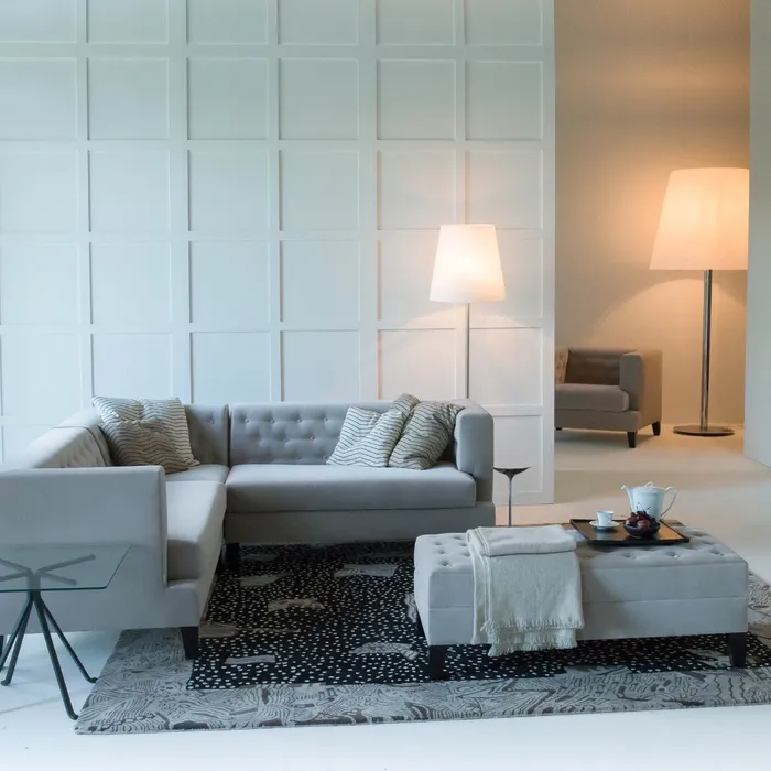 “Hall Armchair by Driade – elegant lounge chair with beige fabric upholstery, classic tufted detailing, and tapered wooden legs, designed by Rodolfo Dordoni, combining traditional English club aesthetics with minimalist Italian design.”