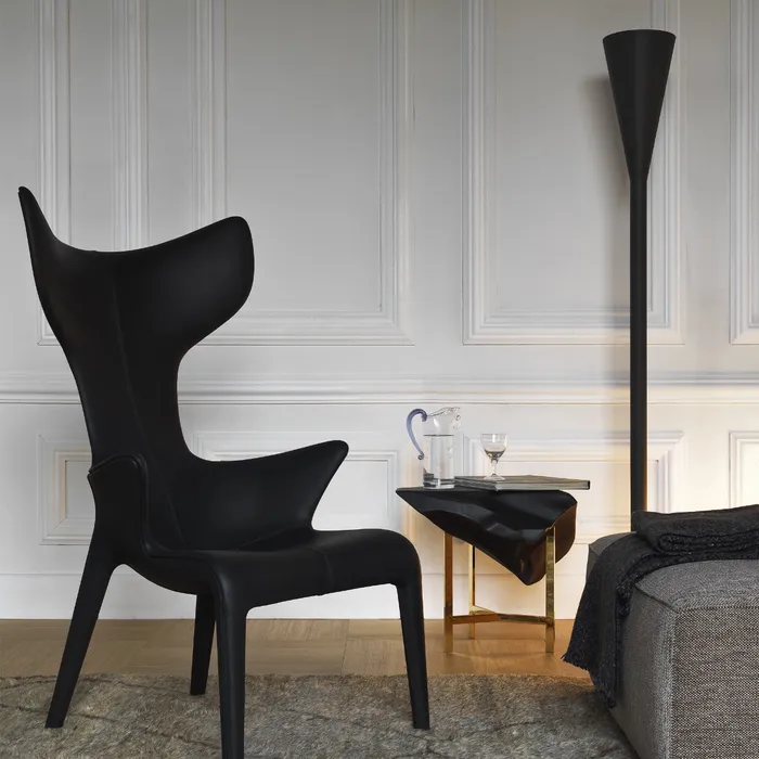 “Lou Read Armchair by Driade – contemporary armchair with white leather cover, hand-stitched onto a fiberglass frame, designed by Philippe Starck and Eugeni Quitllet, combining minimalist design with luxurious comfort.”