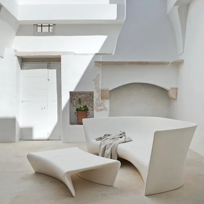“Side profile of Grand Plié Sofa by Driade – minimalist design showcasing the curved silhouette and seamless polyethylene construction, ideal for contemporary lounge areas.”