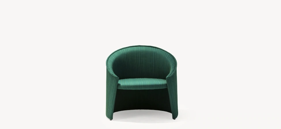 Husk armchair by Moroso in contoured Italian fabric shell with slim metal legs, front view in a Royal Oak Michigan showroom
