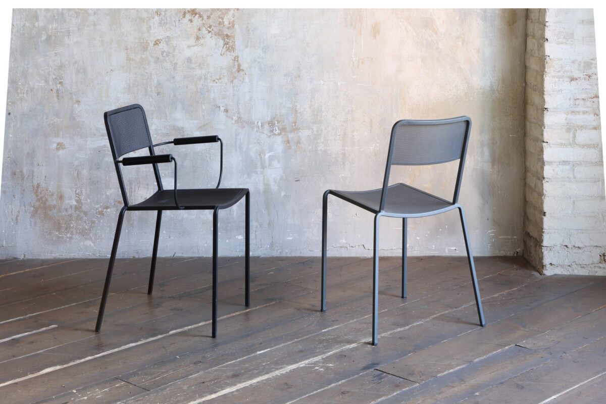 “Close-up of Ginger 2018 Armchair's seat and backrest, emphasizing the fine perforations and the subtle upturned edges for added comfort.”