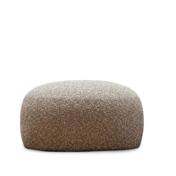 Pacific pouf by Moroso in soft camel-colored fabric with smooth rounded edges, placed next to a modern sofa