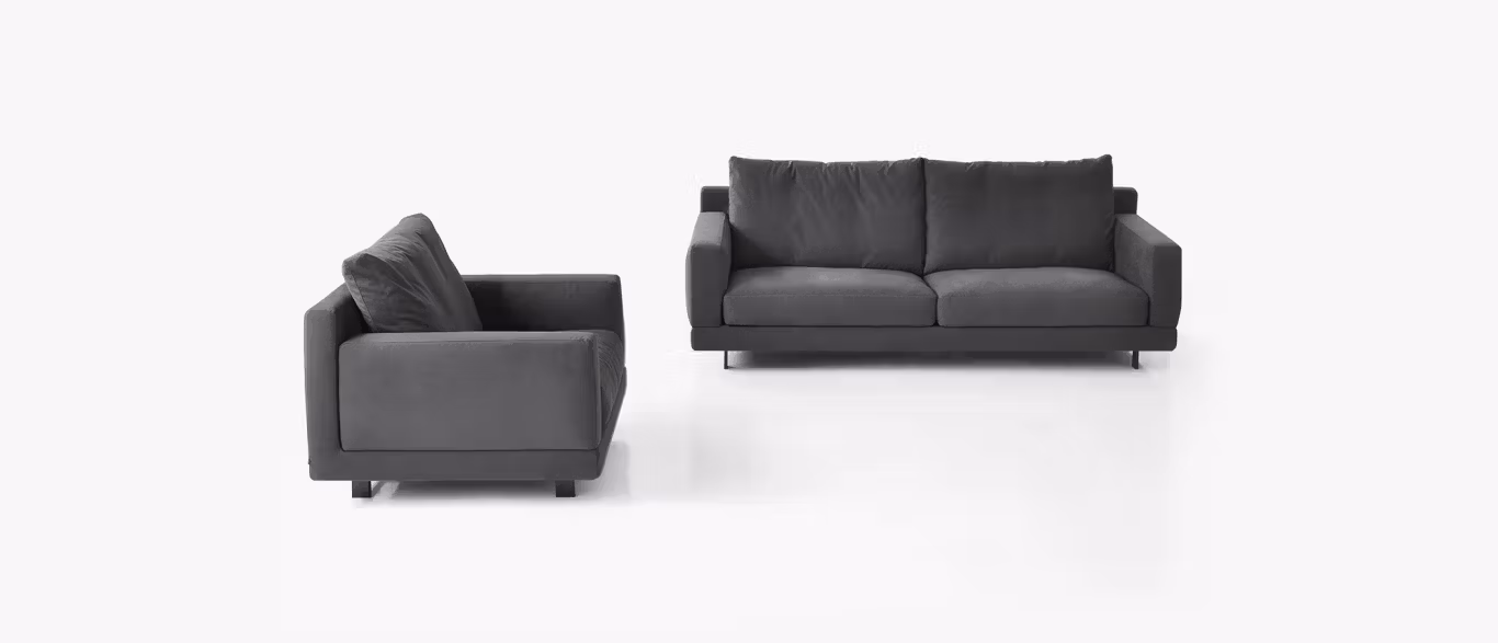 Elle by Bensen lounge chair in light beige fabric with fluid curves and slim metal base in a contemporary living space