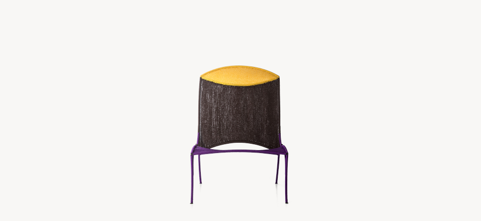 Arco armchair in bold red and orange hand‑woven polyethylene netting over painted steel frame, with high curved back