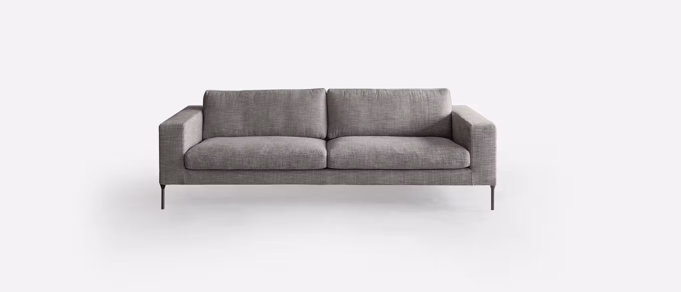 Neo by Bensen lounge chair in light gray fabric with slim black metal legs in a modern living room