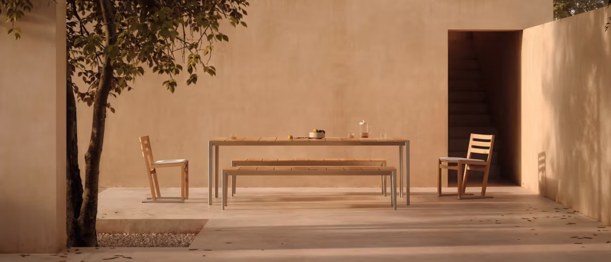 Outdoor Lean Chair by Bensen in dark gray weather-resistant fabric with black metal frame on a stone patio