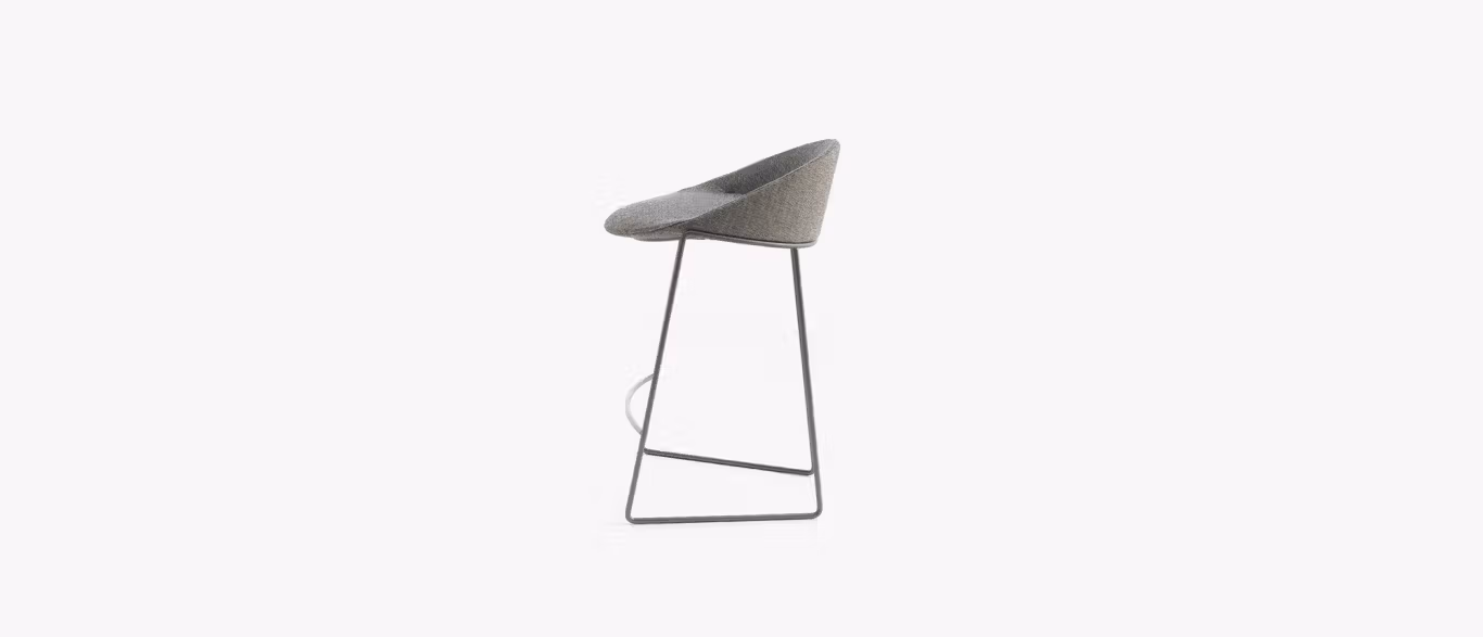 Circa Stool by Bensen in light gray upholstery with slim black metal legs in a modern kitchen setting
