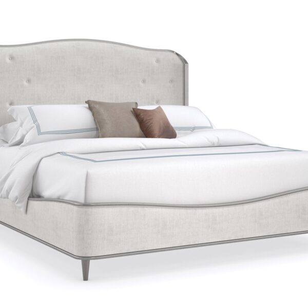 Caracole Clear The Air King Bed featuring a neutral performance linen upholstered headboard with button-pull details, footboard, and side rails, accented with Silver Charm wood trim and legs.