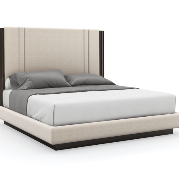 Caracole Decent Proposal King Bed featuring a light-toned performance fabric upholstered headboard, footboard, and side rails, with Dark Chocolate trim and Champagne Gold metal inlay accents, set on a Dark Chocolate plinth base.
