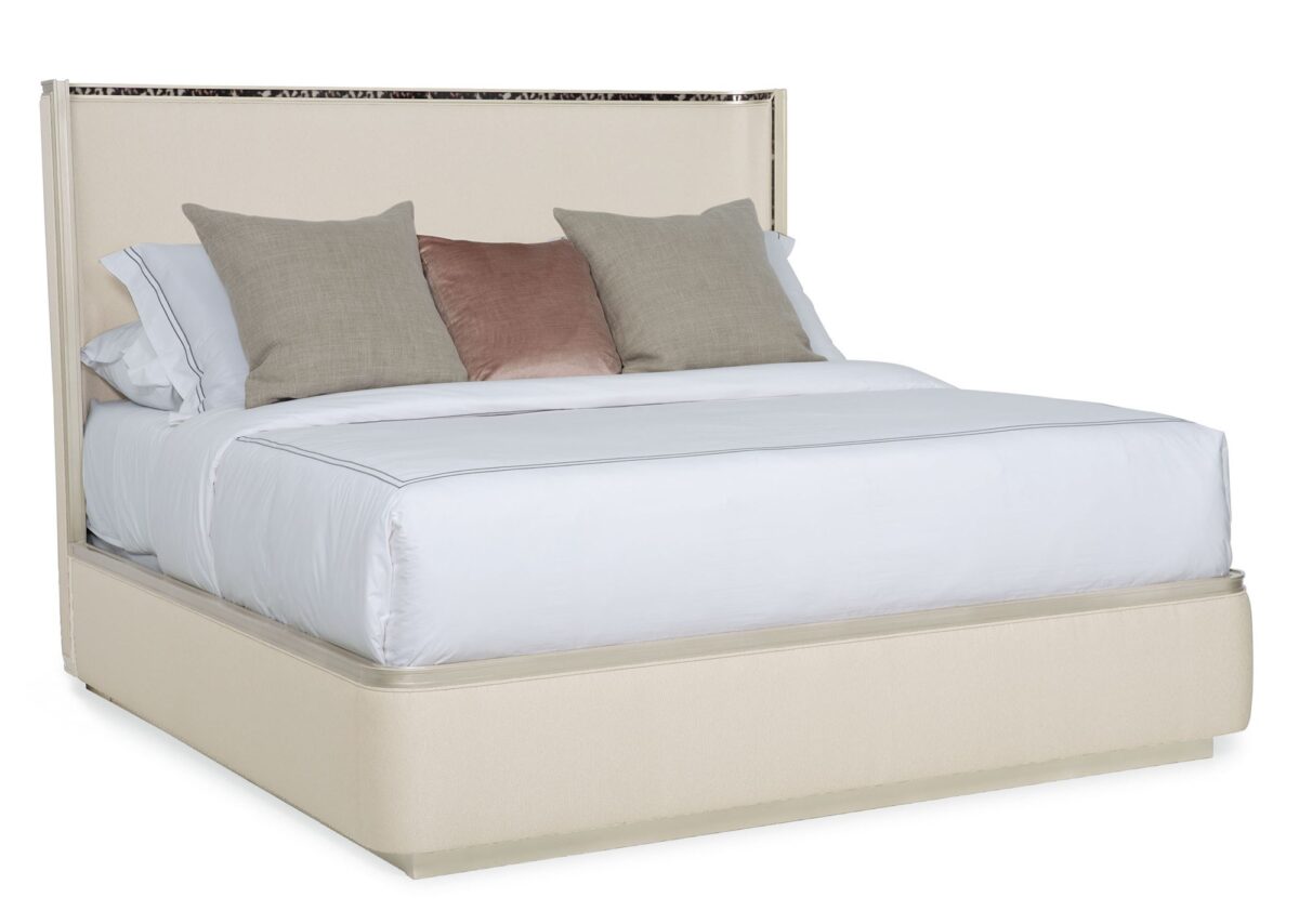 Caracole Dream Big California King Bed featuring a gently curving headboard with acrylic tortoise shell-inspired inlay, upholstered footboard and side rails in performance fabric, and a contemporary plinth base in Soft Silver Paint.