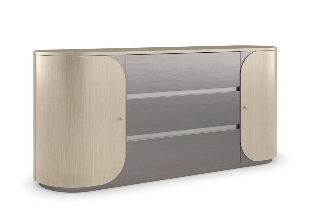 Vita Duo Dresser by Caracole—a sleek oval dresser with dual-tone Smoked Stainless Steel finish, featuring two curved doors with subtle wood grain and three central drawers for a modern minimalist aesthetic.