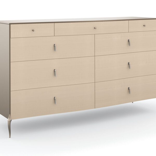 Dress to Impress Dresser by Caracole — a 62″ wide nine‑drawer dresser in soft‑silver painted Asian hardwood case, with vanilla‑cream figured‑sycamore drawer fronts, elongated Art‑Deco style metal pulls, a gently curved top, ornate silver‑toned legs, and two felt‑lined top drawers.