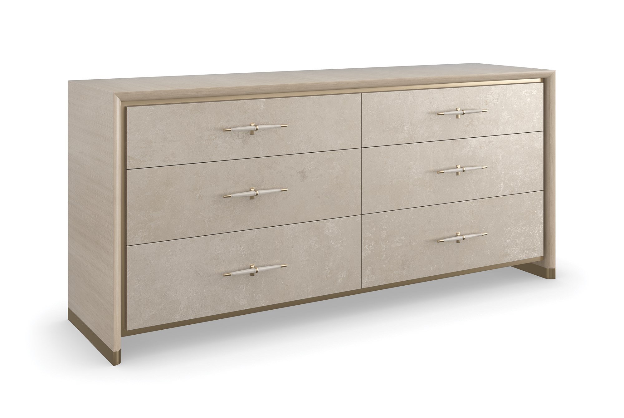 Hang Up Dresser by Caracole — a 70‑inch wide classic dresser with six drawers featuring metallic leaf-finish fronts that shimmer like frosted glass, set in a Dry Martini-finished hardwood frame with recessed metal trim, tapered faux‑leather-wrapped pulls in brushed gold and nickel, soft‑close drawers, and linen-painted interior with top drawer dividers and a removable jewelry tray.