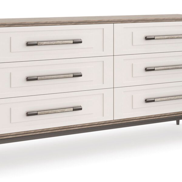 Impressive Dresser by Caracole — a 72″‑wide transitional dresser in Mountain Smoke–finished silver Curupixa veneer, with six stepped Pearly White drawer fronts trimmed in deep bronze metal, featuring jewelry‑style ceramic‑inlay hardware, soft‑close undermount guides, and a coordinating deep bronze metal base.