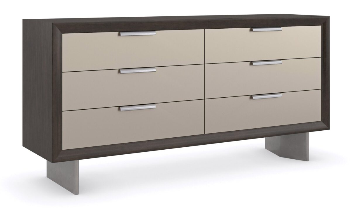 Fashion Dresser by Caracole — a curving six-drawer dresser in lustrous gold-leaf finish, topped with a mirrored bronze surface and slender tapered legs; each drawer features jewelry-like ring pulls and undermount soft-close operation.
