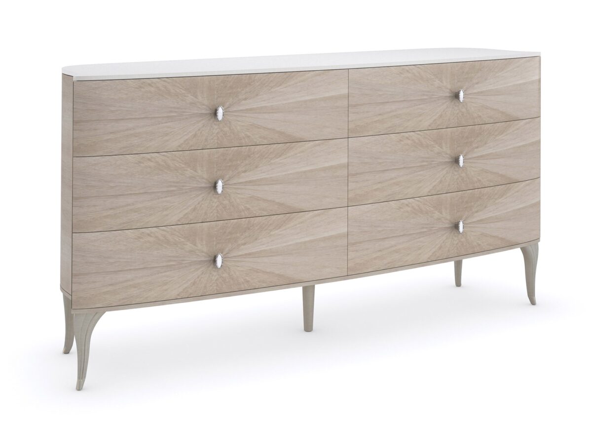 LILLIAN double dresser by Caracole — a 75″ wide glam dresser with six soft‑close drawers featuring radiating sunburst-patterned koto veneer in Stone Manor finish, accented by Art Deco ceramic-inset ring pulls, carved cabriole legs in shimmering Soft Radiance paint, and a contrasting Ivory Wash top.