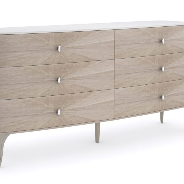 LILLIAN double dresser by Caracole — a 75″ wide glam dresser with six soft‑close drawers featuring radiating sunburst-patterned koto veneer in Stone Manor finish, accented by Art Deco ceramic-inset ring pulls, carved cabriole legs in shimmering Soft Radiance paint, and a contrasting Ivory Wash top.