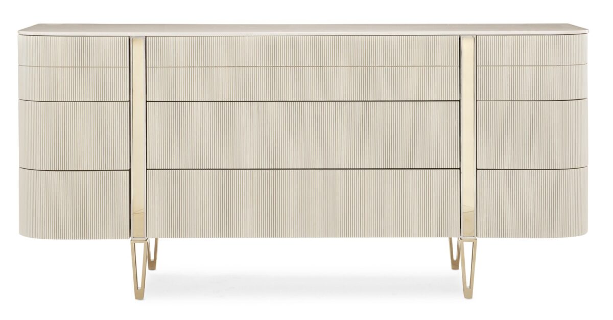 Love at First Sight Dresser by Caracole — a 74″‑wide curved‑front dresser in Matte Pearl finish with nine touch‑latch, reeded drawer fronts, soft‑close undermount guides, and Whisper‑of‑Gold metal legs and band accents.