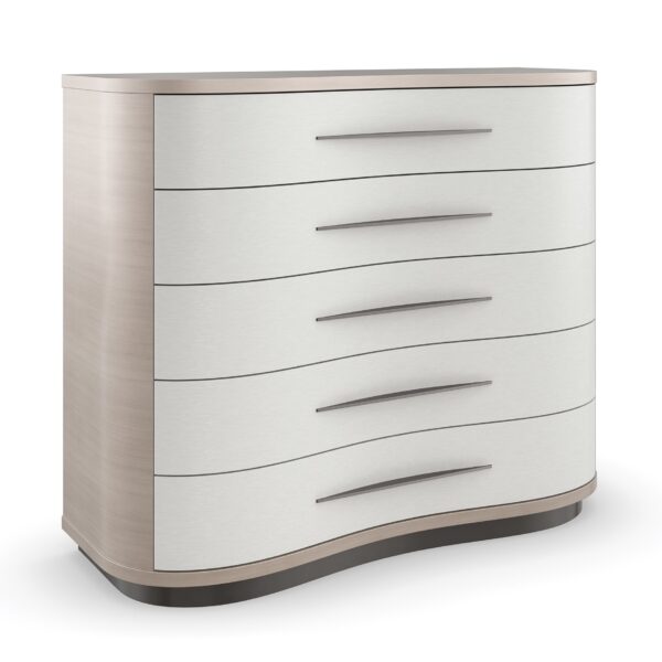 Meandrous Dresser by Caracole — a 50″‑wide organically curved dresser with five vinyl‑wrapped drawers in pearlescent Moonstone finish, set in a subtle Seal Skin‑tone plinth base; features horizontal bronze-tone handles, soft‑close undermount guides, painted interiors, a radial‑pattern Koto veneer top, and a removable jewel tray in the top drawer.