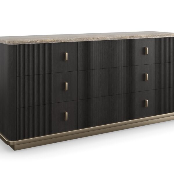 Rhythm Dresser by Caracole — a 69½″ wide six-drawer dresser featuring tactile reeded drawer fronts in Sun Drenched Oak finish, topped with creamy Travertine stone and set on a low neutral‑metal plinth, with rounded corners, bronze bar pulls, and soft‑close undermount guides.