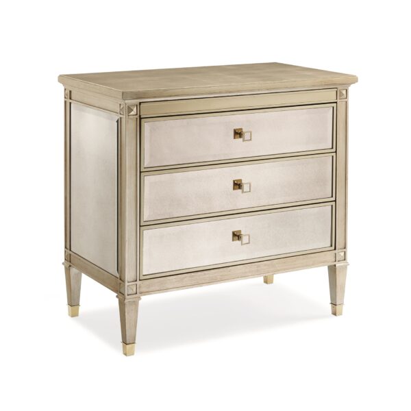 A Classic Beauty by Caracole — a 32″ wide Italian-inspired nightstand with three soft-close drawers featuring beveled antique-mirror fronts framed in Auric silver leaf finish, square mirrored-inset pulls, carved tapered feet with metal ferrules, and a sparkling gold-painted interior shelf.