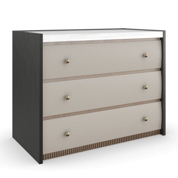 Avignon Bronze Nightstand by Caracole — a 34″‑wide classic nightstand with three soft‑close drawers featuring tactile Rockport Burnished Adobe fronts, set within Craftsman Bronze‑painted end panels; topped with striated white Guangxi stone, trimmed with antique‑bronze‑leaf dentil molding at the base, brushed‑gold ball knobs, and painted Almond Milk interiors.