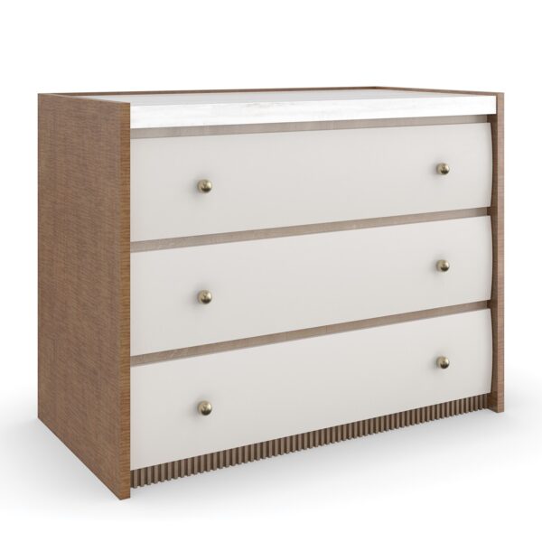 Caracole Avignon Nightstand — a 34″‑wide three‑drawer nightstand with tactile Rockport Burnished Adobe drawer fronts, topped with a striated white Guangxi/onyx stone surface, flanked by Toasted Sycamore end panels, adorned with antique‑bronze‑leaf dentil molding at the base, and brushed‑gold ball knobs on soft‑close undermount guides.
