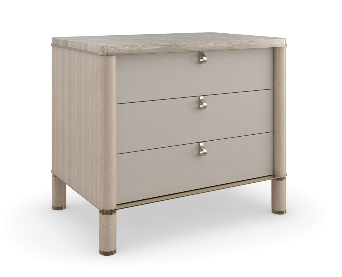 Balance Drawer Nightstand by Caracole — a 28″‑wide modern nightstand in Cremini-finished hardwood with three soft‑touch vinyl-wrapped drawers, topped in polished Silver Travertine stone and supported on round Cremini legs with Lucent Bronze-metal accents and trim.