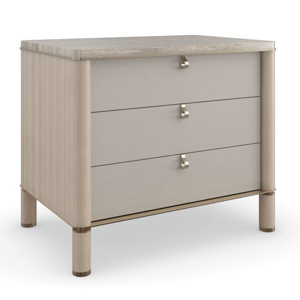 Balance Drawer Nightstand by Caracole — a 28″‑wide modern nightstand in Cremini-finished hardwood with three soft‑touch vinyl-wrapped drawers, topped in polished Silver Travertine stone and supported on round Cremini legs with Lucent Bronze-metal accents and trim.