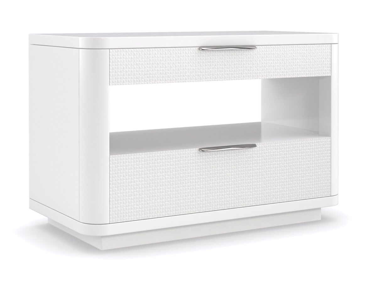 In Touch by Caracole" refers to a bedside table/nightstand. It's characterized by rounded edges, a clean-lined "Cloud White" finish, carved drawer fronts with a "woven mini-tile motif," finger-cup pulls in Satin Nickel, two drawers, and open center storage with a built-in light, a USB port, and wire management holes.