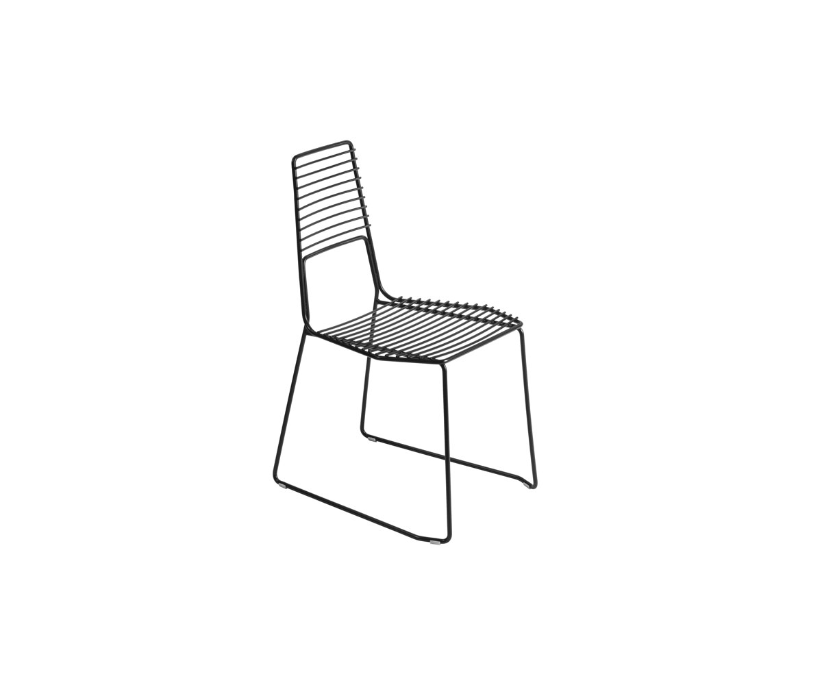 "Alieno Chair by Casamania in black painted metal with a minimalist sled base, highlighting its sleek structure, high backrest, and textured finish, set in a modern outdoor patio."