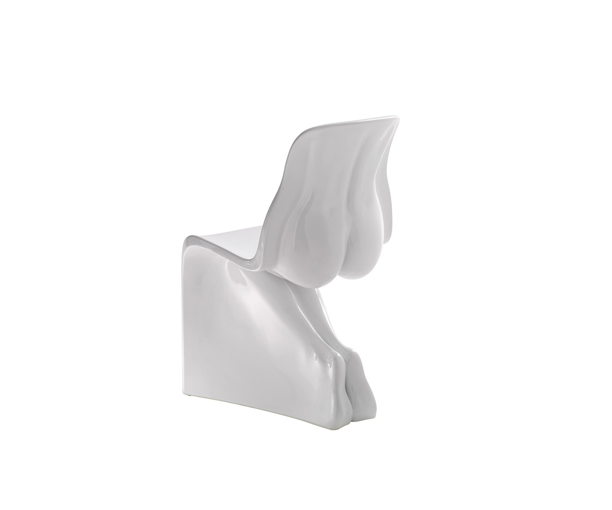 "Her Glossy chair by Casamania, designed by Fabio Novembre, features a sculpted female form in glossy painted polyethylene, inspired by the Panton Chair and crafted using 3D scanning of plaster sculptures."