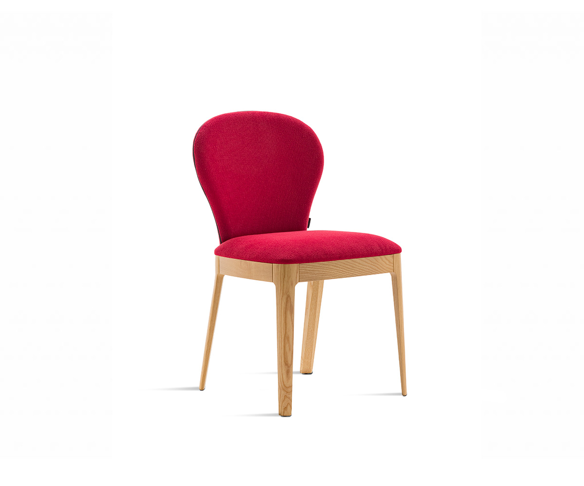 "Milady upholstered chair by Casamania & Horm, designed by Studio Balutto, featuring a sinuous Art Deco-inspired silhouette, solid ash wood frame, and padded seat and backrest available in fabric, faux leather, or leather."