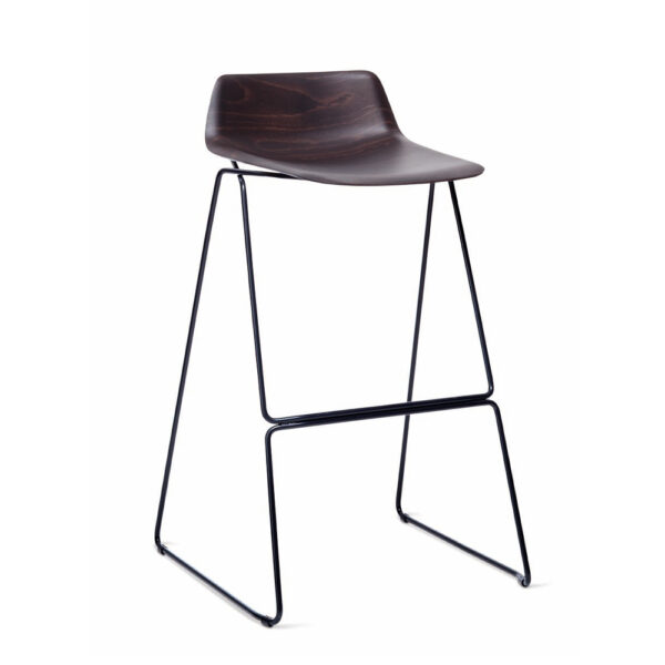 Pressious Stool by Casamania & Horm – Designed by Harry & Camila, featuring a sculptural beech plywood seat shaped using advanced 3D technology, complemented by a black painted metal sled base, suitable for both residential and commercial spaces.
