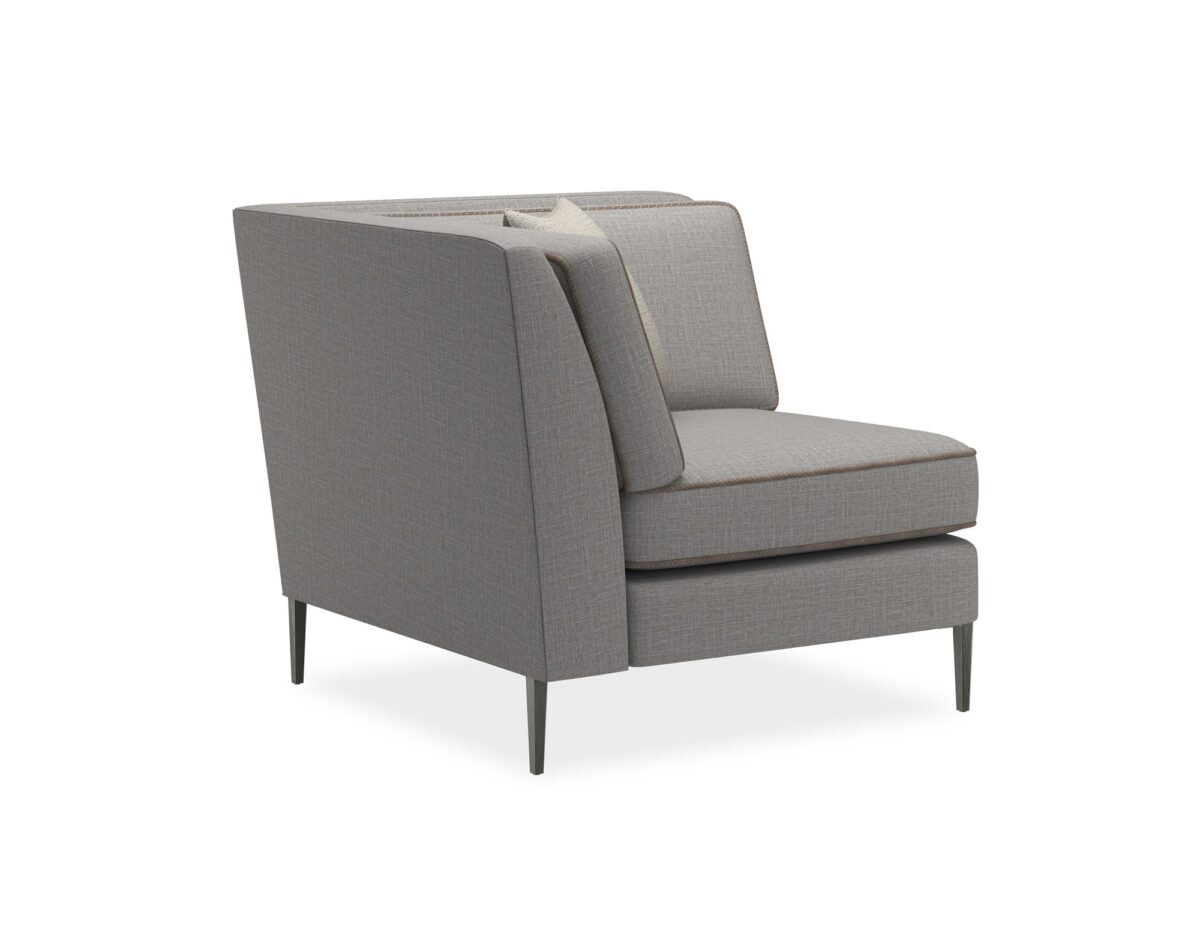 A modern corner chair featuring a clean silhouette with a suspended frame and slim tapered metal legs in Smoked Stainless finish.