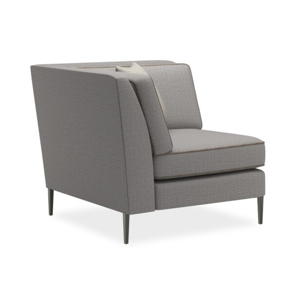 A modern corner chair featuring a clean silhouette with a suspended frame and slim tapered metal legs in Smoked Stainless finish.