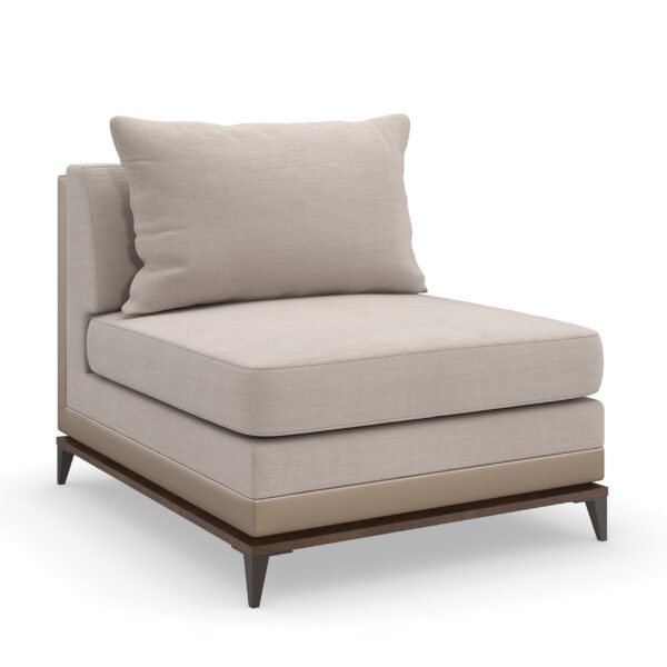 Caracole Archipelago Armless Chair featuring neutral twill upholstery with faux leather accents, exposed Bourbon Glaze wood base, and Deep Bronze metal legs, complemented by a reversible saffron velvet and embroidered geometric pillow.