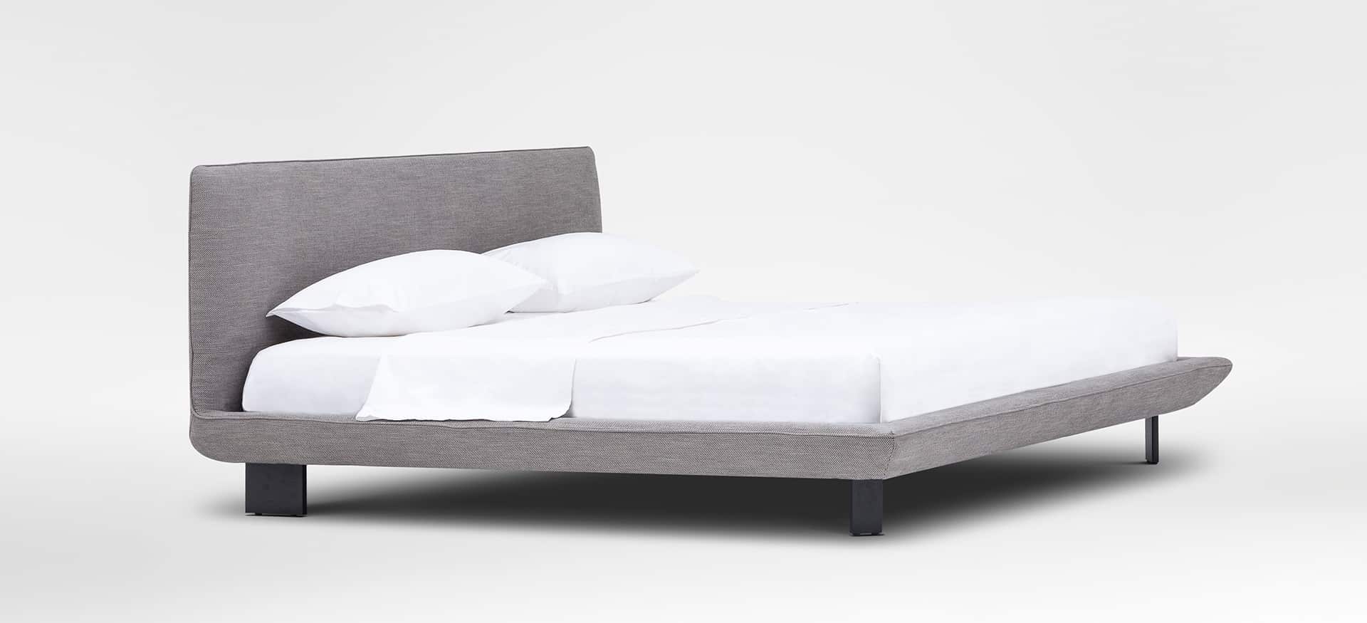 Modern platform bed with slim frame and padded headboard by Camerich.
