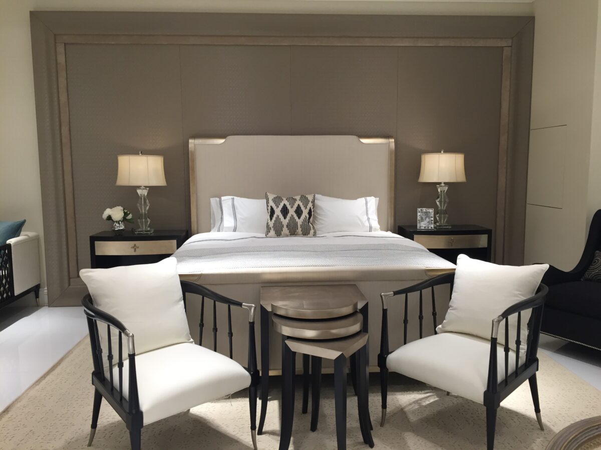 Caracole Nite In Shining Armor King Bed featuring an elegant wood frame in an aged leaf finish reminiscent of old silver, with fabric insets showcasing a small ribbed weave in off-white and light oyster coloration.