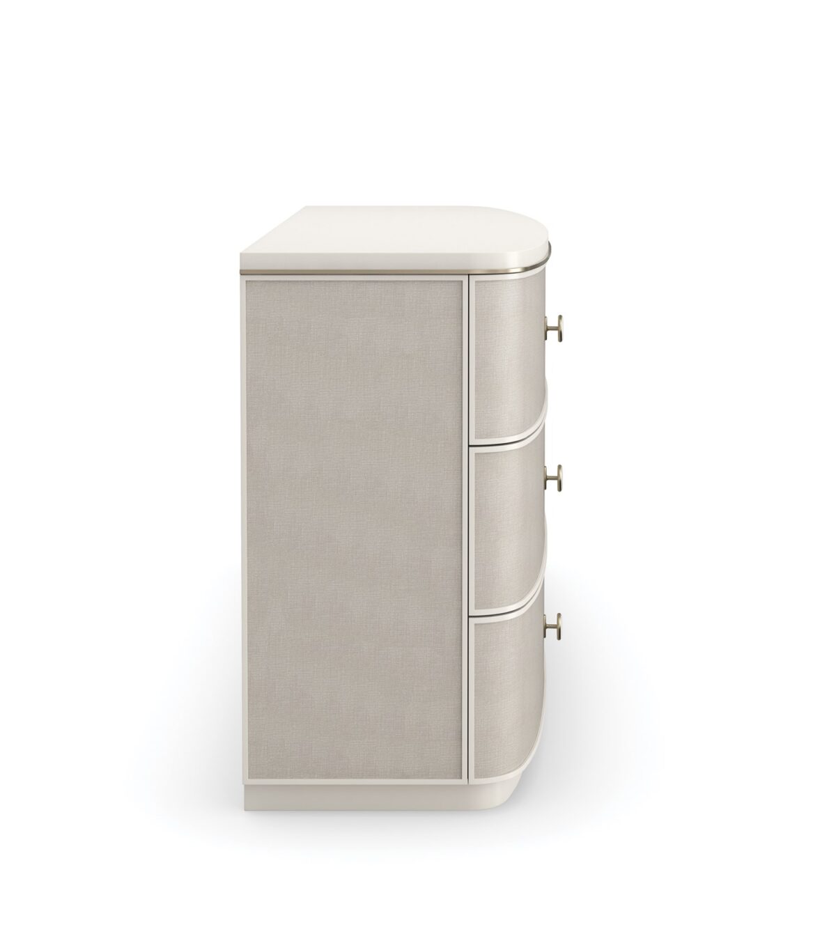 Lyon Dresser by Caracole — a 64″‑wide sculptural dresser in Almond Milk faux‑linen vinyl finish, with softly curved sloping sides and six vinyl‑wrapped drawers featuring painted Interiors, all set on a clean plinth base and trimmed with a slender Brushed‑Gold metal bead.