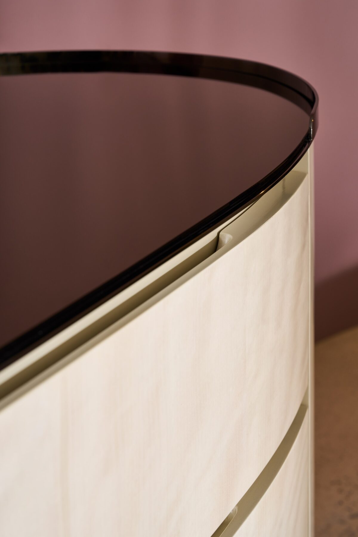 Muse Dresser by Caracole — a 79½″‑wide oval double dresser combining Nebulous‑finish Curupixa wood with a Dark Chocolate base, featuring six softly curved soft‑close drawers with grooved finger pulls, two end‑panel doors concealing jewelry and tie storage, topped with a Smoked Bronze mirrored surface framed in Deep Bronze metal.