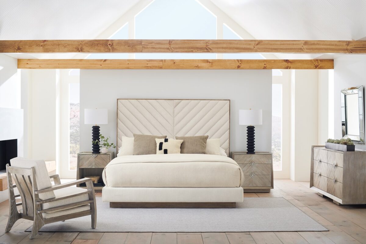 Naturally Dresser by Caracole — a 74″‑wide six‑drawer dresser in Ash Driftwood finish with chevron‑patterned wood‑veneer fronts, accented by a slender Sundance Gold metal bead edging and recessed drawer pulls, all sitting on low block feet.