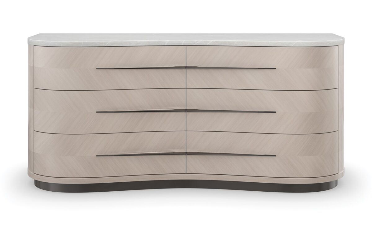 Roam Dresser by Caracole — a sleek 68″‑wide dresser in pearlescent Moonstone finish with six gently curved soft‑close drawers featuring horizontal Deep Bronze handles; chevron‑patterned Koto veneers flow organically across the fronts and end panels, topped with luxurious white Rhino marble and set atop a Seal‑Skin tone plinth base.